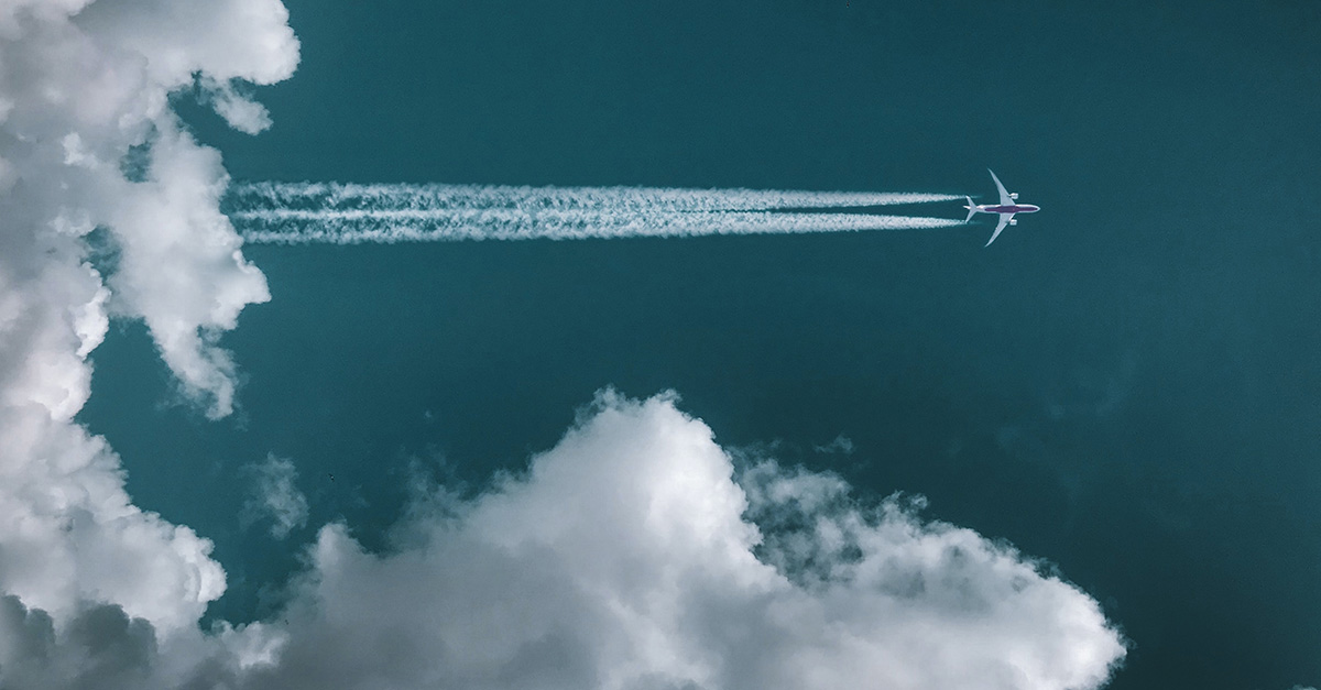 jet soaring above clouds